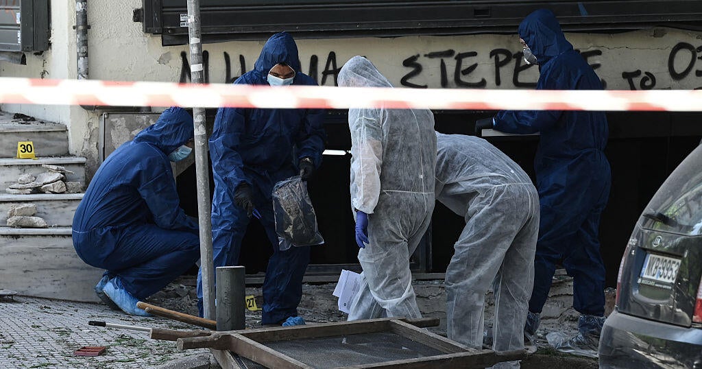 Woman carrying bomb killed after it explodes before she could place it outside bank, police say