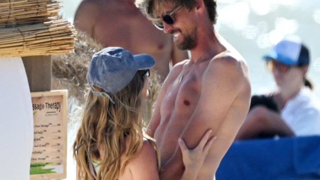 Abbey Clancy flashes her bum on the beach as she cosies up to hubby Peter Crouch
