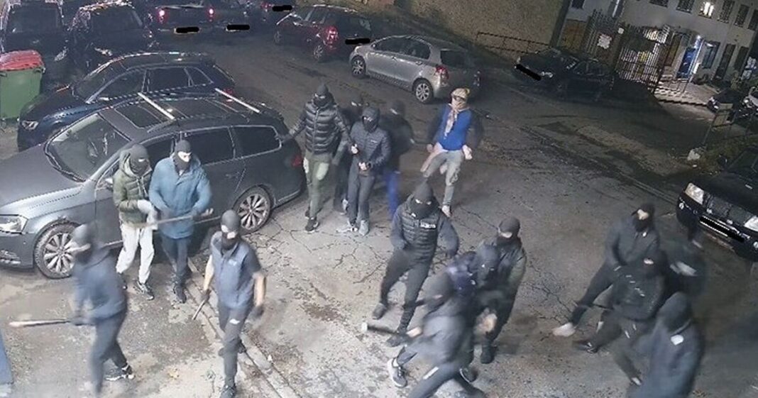 Terrifying moment 17 masked yobs armed with bats and metal bars descend on garage | UK | News