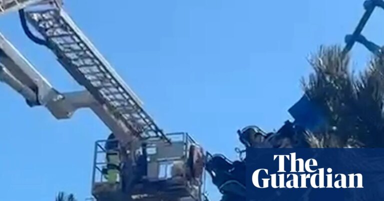 Firefighters rescue 27 people from broken down rollercoaster in Suffolk – video | Theme parks